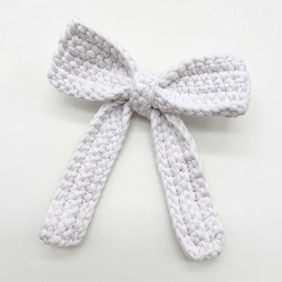 Chenille crocheted hair bow laid flat