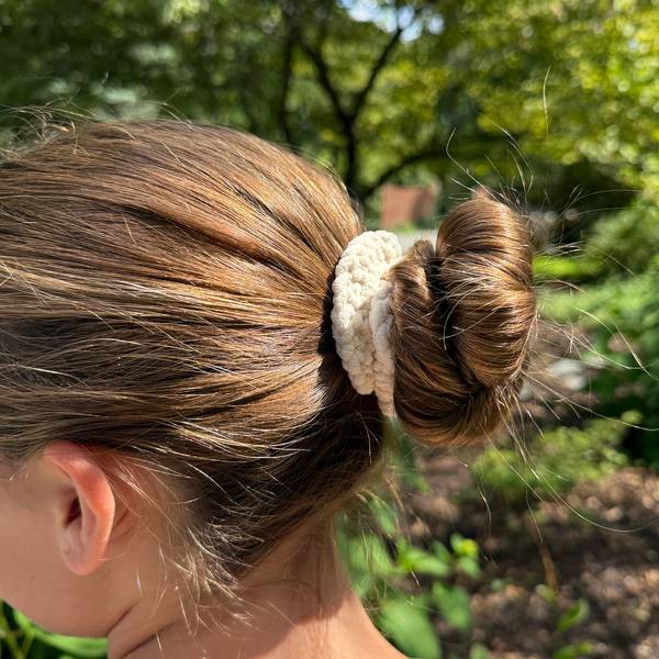 The scrunchie holding a loose bun